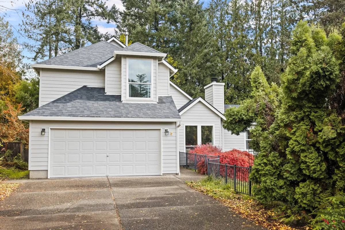 An inviting exterior view of the house showcasing its welcoming facade, garage door, well-maintained landscaping, and a cozy front porch. The scene exudes a sense of homecoming and community, with space for outdoor gatherings and play.