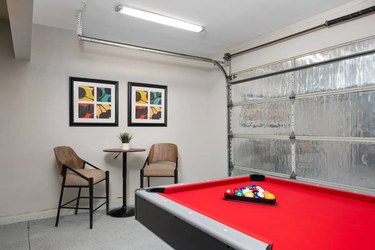 This image spotlights another angle of the entertainment area, with a focus on the pool table, stylish wall art, and a comfortable seating nook. The arrangement is ideal for hosting game nights or celebrating special occasions.
